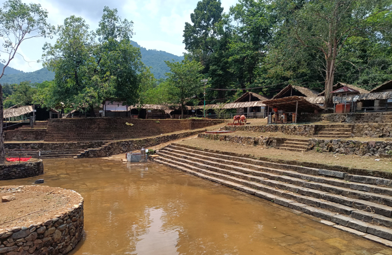 Kottiyoor Vaishakha Mahotsavam — pilgrims gathered at Akkare Kottiyoor in the monsoon forest of Kannur, Kerala, for the annual 28-day pilgrimage at the site where Daksha Yaga occurred and where the Swayambhu Shivalinga rests on a Manithara river-stone platform, with the temporary shrine built from bamboo, palmyra and coconut leaves