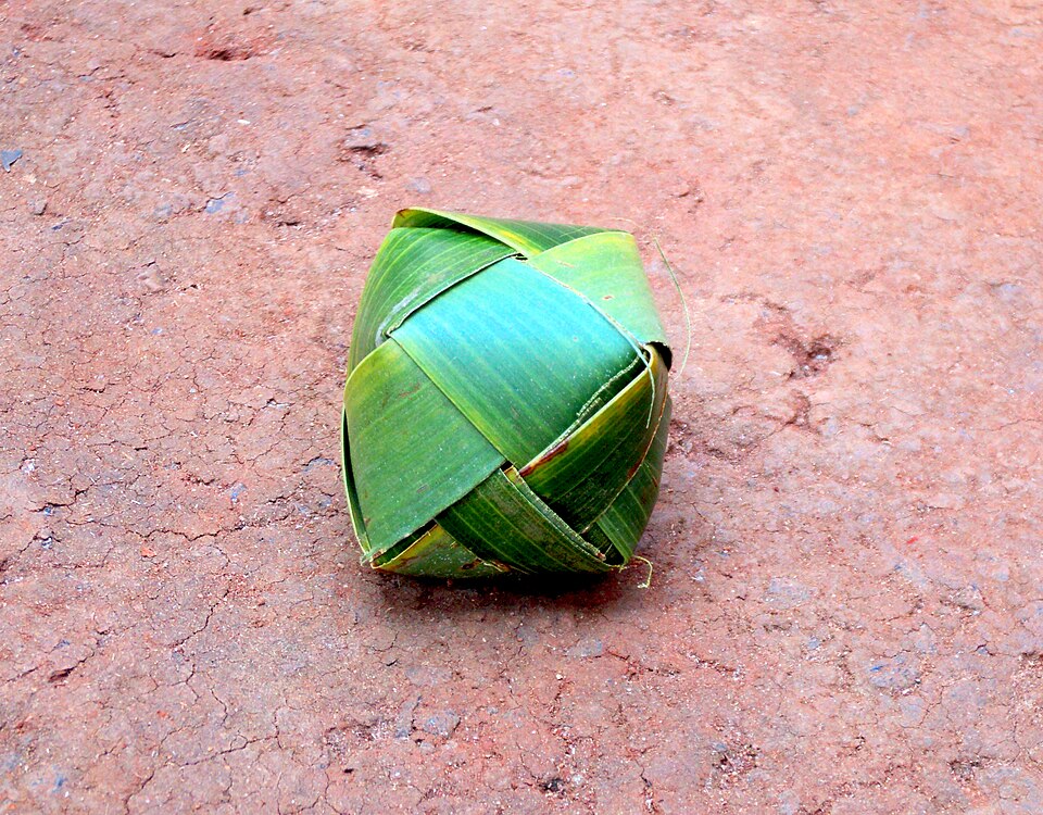 Olappanth — the traditional Kerala palm leaf ball, hand-woven from dried coconut palm leaves by children before play. The ball itself is the first craft object Kerala's children learned to make, embodying the principle that the best toy is the one you make yourself