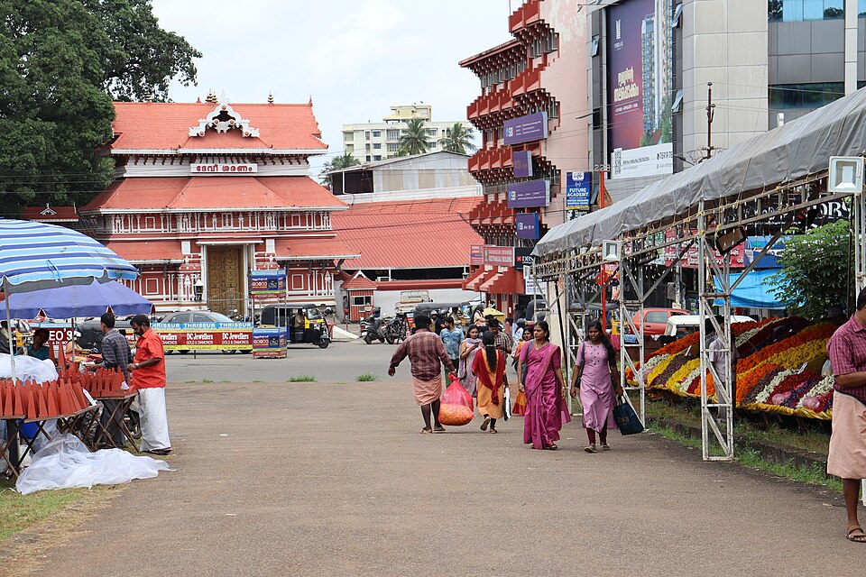 Onam flower market — the bustling flower stalls that appear across Kerala in the days before Thiruvonam, selling marigold, chrysanthemum, globe amaranth, and other flowers for Onappookkalam, filling streets with colour and the sweet-sharp fragrance of fresh blooms during the Onam season